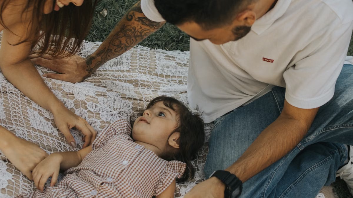 Relaxing family picnic with parents and child outdoors on a summer day.